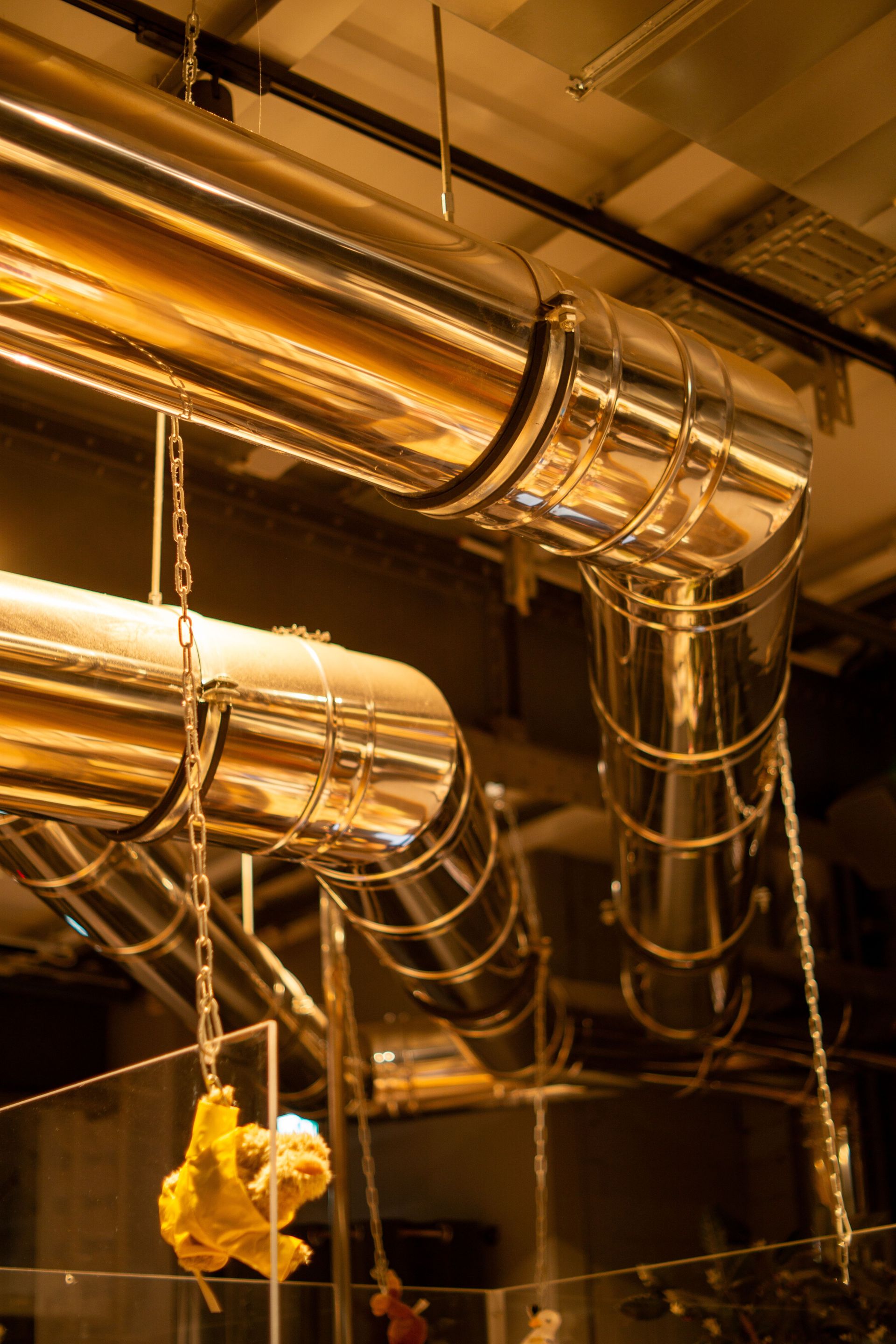 Shiny metallic ductwork in an industrial setting, showcasing modern architecture in Hamburg.